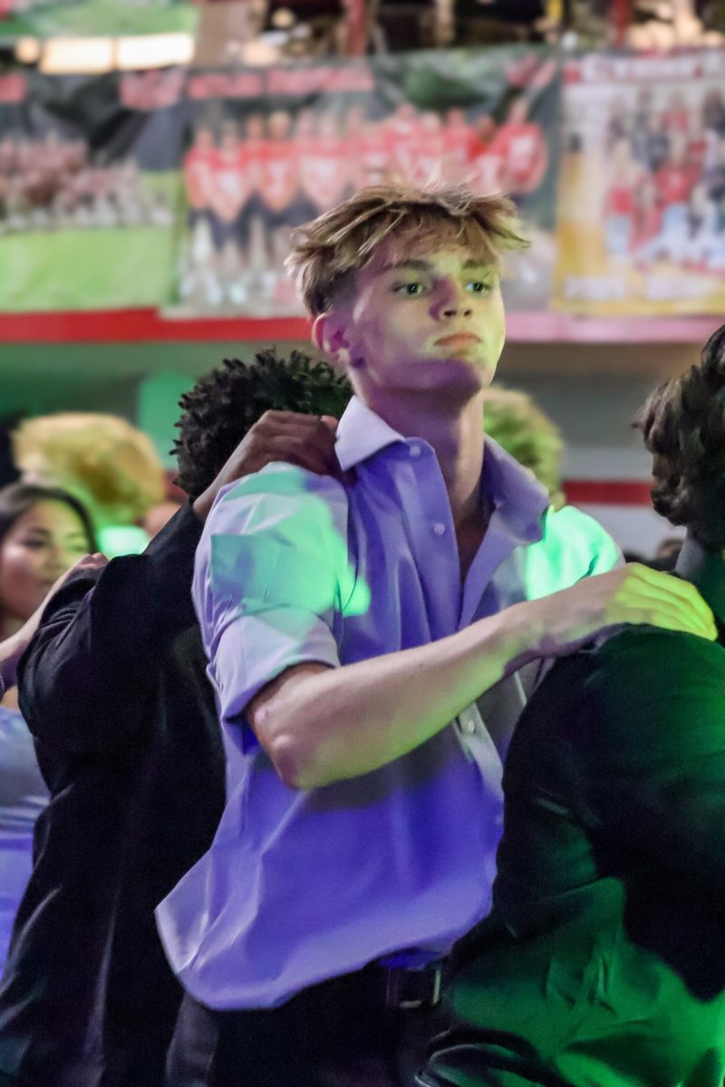 Junior Matthew Ott dances in the train line alongside other students at homecoming. Homecoming took place on Sept. 20th, 2025.