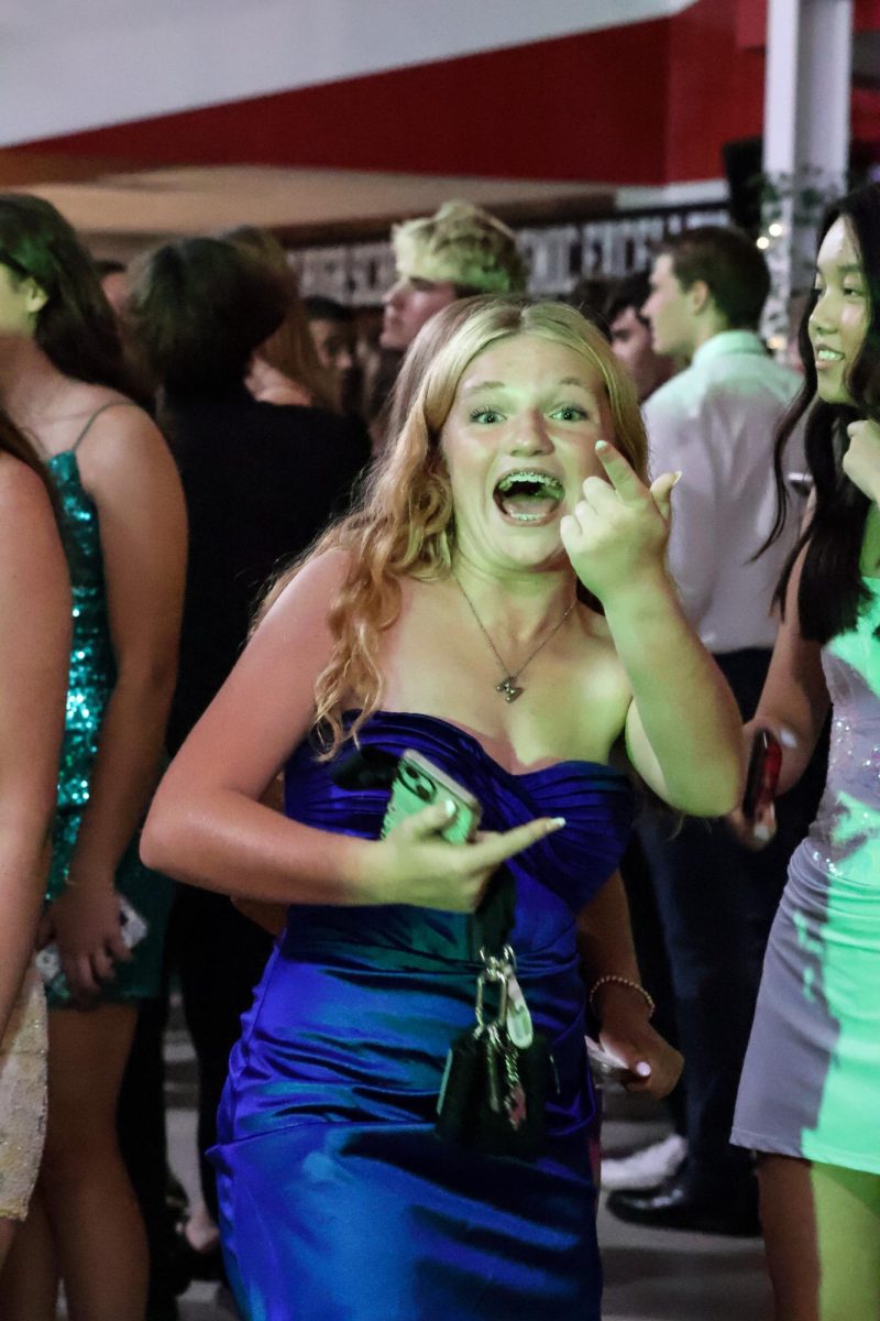 Junior Makenna Overturf points and smiles at the camera while she dances at homecoming. Homecoming took place on Sept. 20th, 2025.