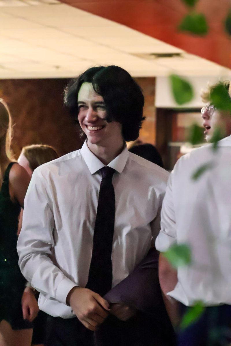 Senior Taylor Kohn smiles around friends during homecoming. Homecoming took place on Sept. 20th, 2025.
