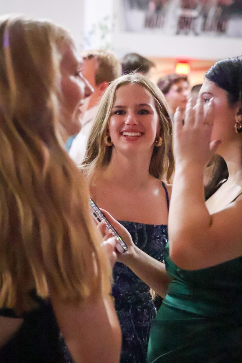 Freshman Lola Traynor dances with friends and poses for the camera at homecoming. Homecoming took place on Sept 20, 2025.