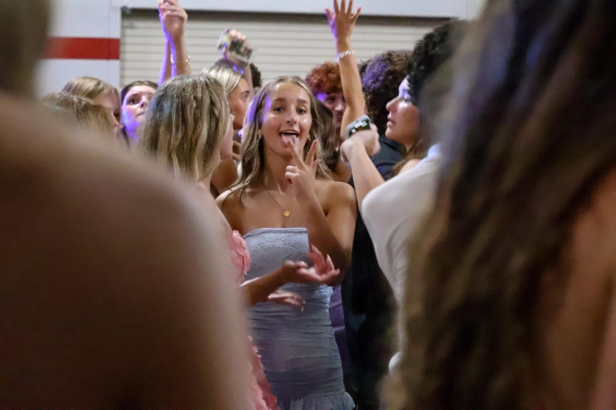 Sophomore Josephine Roeber poses with a peace sign mid-dance at homecoming. Homecoming took place on Sept 20, 2025.