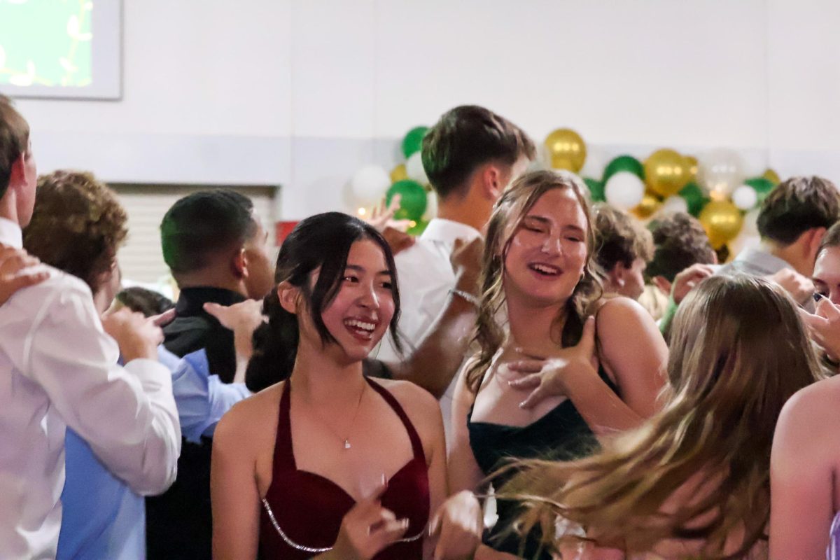 Juniors Ronna Tu and Noelle Dutoit dance and sing with friends at homecoming. Homecoming took place on Sept. 20th, 2025.