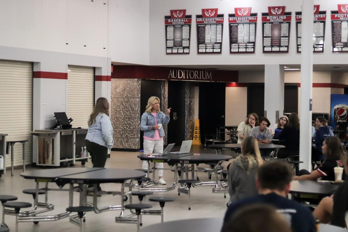 NHS sponsor Ronda Habrock talks to the NHS members at the first meeting after the induction ceremony. New members were inducted Sept. 7. NHS meets in the commons once a month during TA.