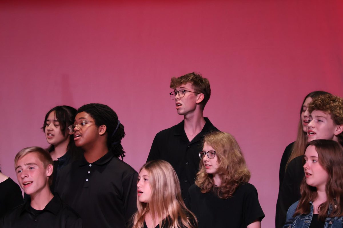 Senior, Max Underwood gets into the song during mixed choir performance.