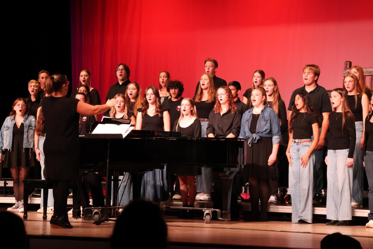 Teacher Abby Thompson conducting the concert choir students.