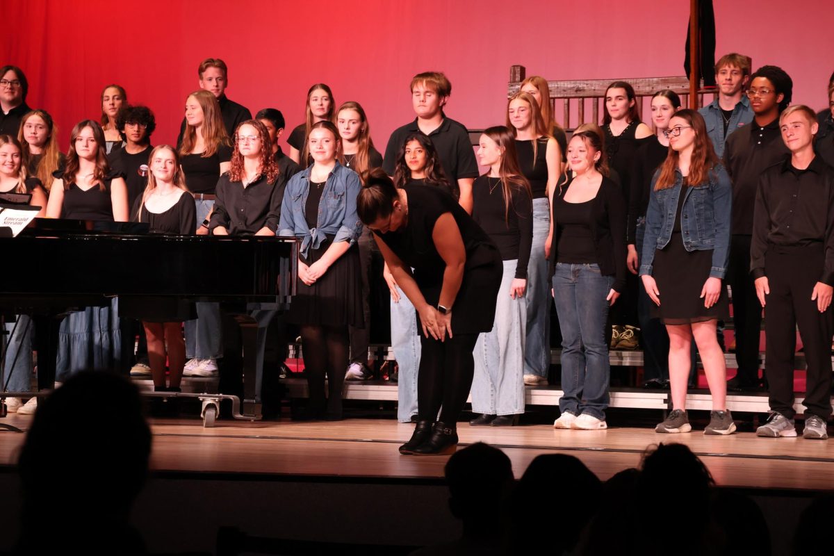 Teacher Abby Thompson bowing after a show stopping performance during a choir concert.