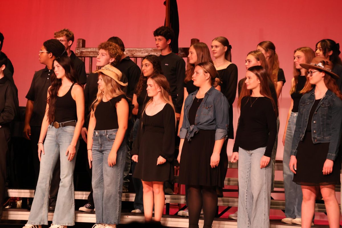 Students in combined choir wait to be cued in. This concert took place in the Elkhorn High school auditorium. 
