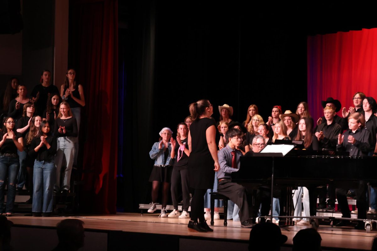 Elkhorn High School choir teacher Abby Thompson leads the combined choir in the song Hoe Down arr by Tom Porter. This concert took place in the Elkhorn High School auditorium. 
