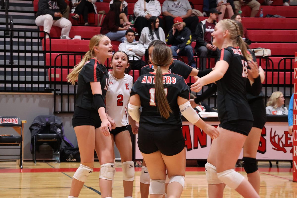 Antler junior varsity volleyball team celebrating after a successful play. 