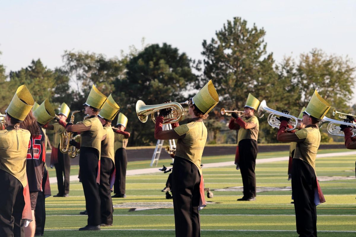 The band doing a run through of parts of the show before their performance. Elkhorn marching band performed on Oct. 11th, 2025.