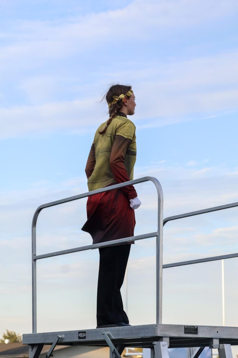 Junior drum major Noelle Dutoit stands on the podium waiting for marchers to be in place. Elkhorn marching band performed on Oct. 11th, 2025.