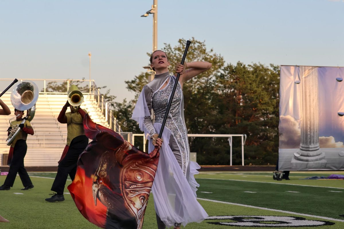 Junior Adison Sant performs with a color guard flag. Elkhorn marching band performed on Oct. 11th, 2025. 