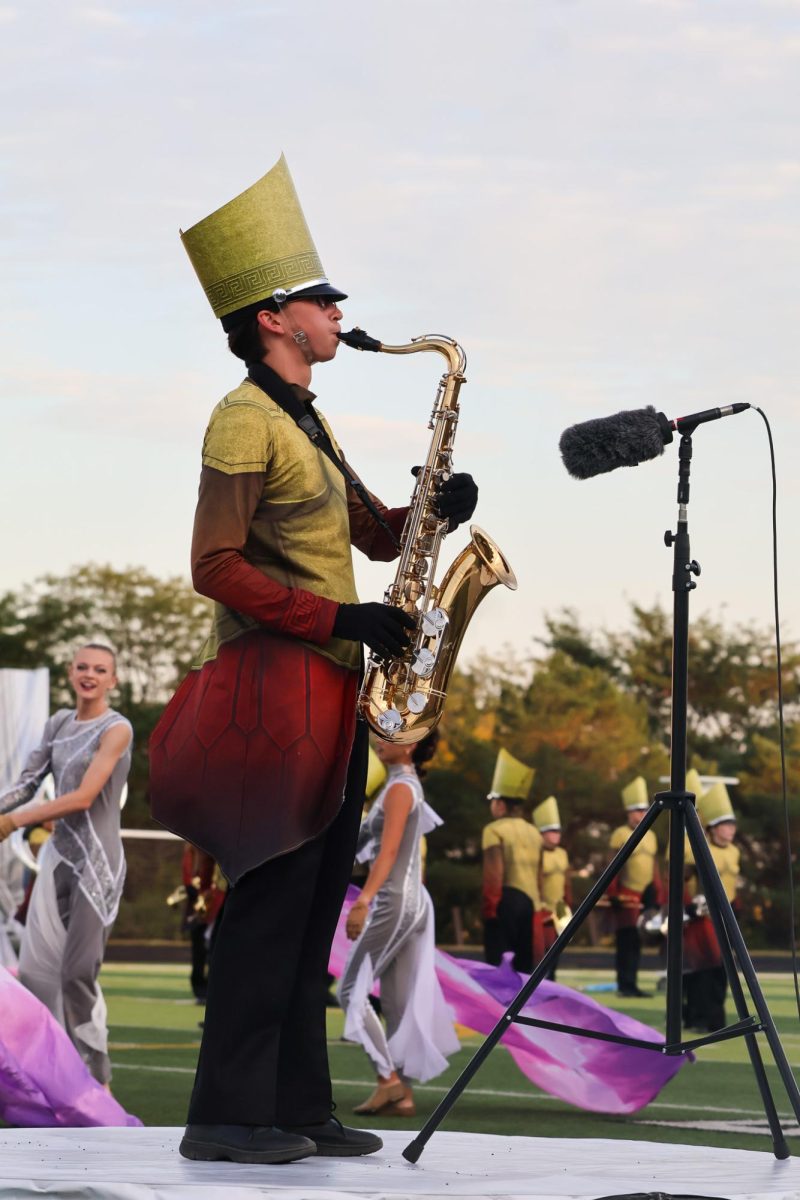 Senior Ivan Ratnapradipa plays the tenor saxophone during his solo performance. Elkhorn marching band performed on Oct. 11th, 2025.