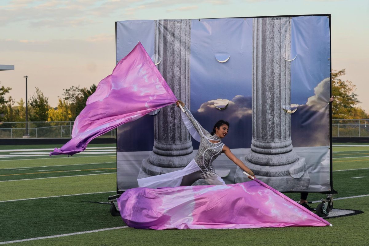 Junior Lola Garces performs Ballad with color guard flags. The Elkhorn marching band performed at the Sounds of Excellence Oct. 11th, 2025.
