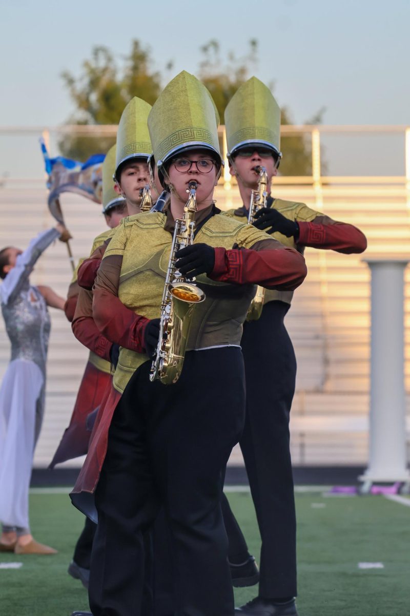 Senior Sarah Lindberg plays the alto saxophone while she marches. Elkhorn marching band performed on Oct. 11th, 2025.