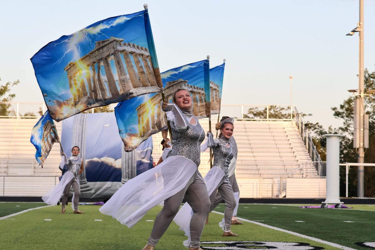 Juniors Lillian Jaworski and Anabelle Bradley spin their flags in the closer of the show. Elkhorn marching band performed on Oct. 11th, 2025.