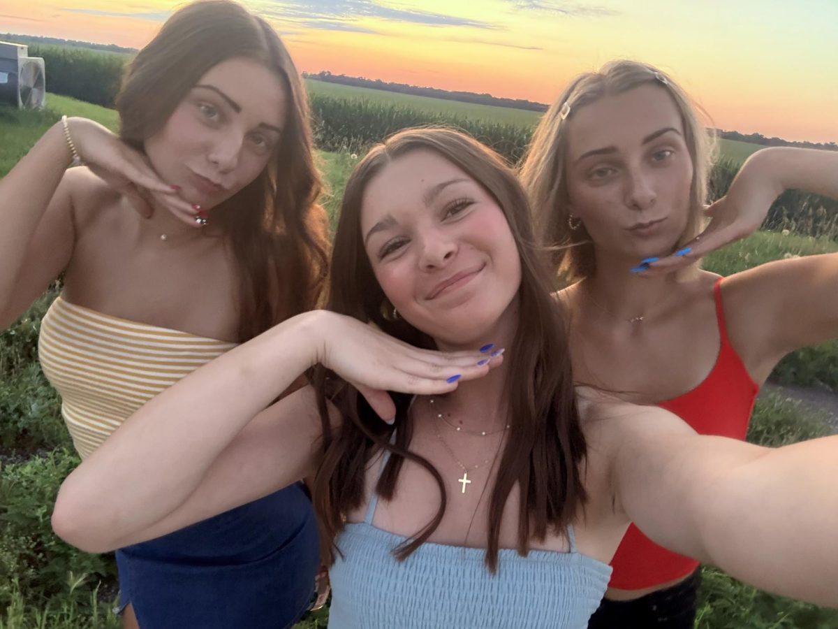 The What A Day Crew, Delaney, Ava and Allyson, glow up at sunset.