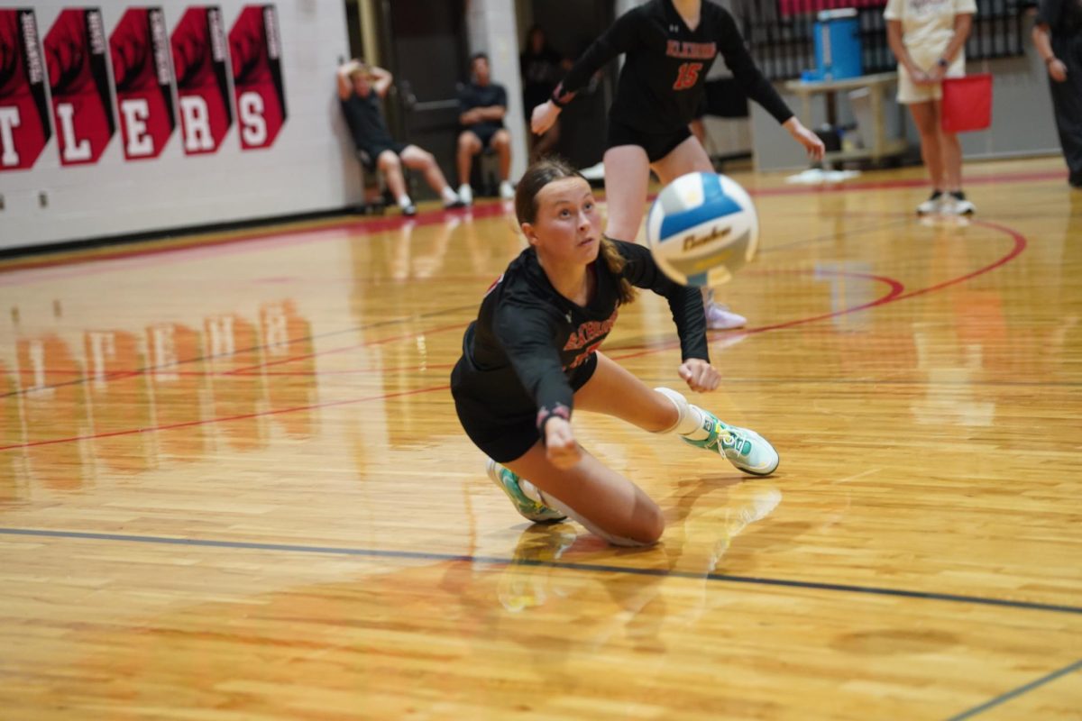 Freshman Emma Byrd lays out to save a ball during the team's game against Gretna East. The Antlers beat the Griffins in five sets.

Photo courtesy of Scott Avery