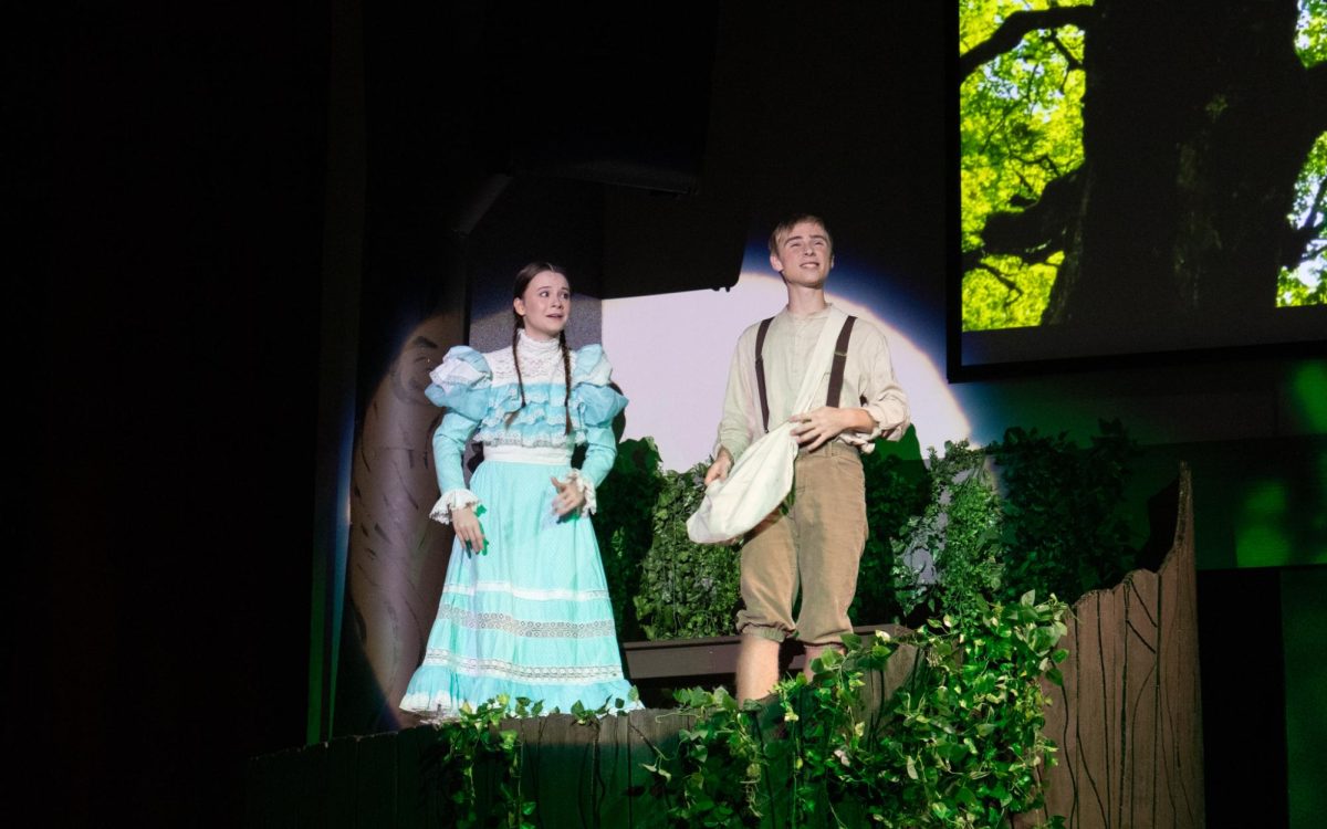 Seniors Nora Cowles and Gage Petrick sing as Winnie Foster and Jesse Tuck in "Tuck Everlasting."