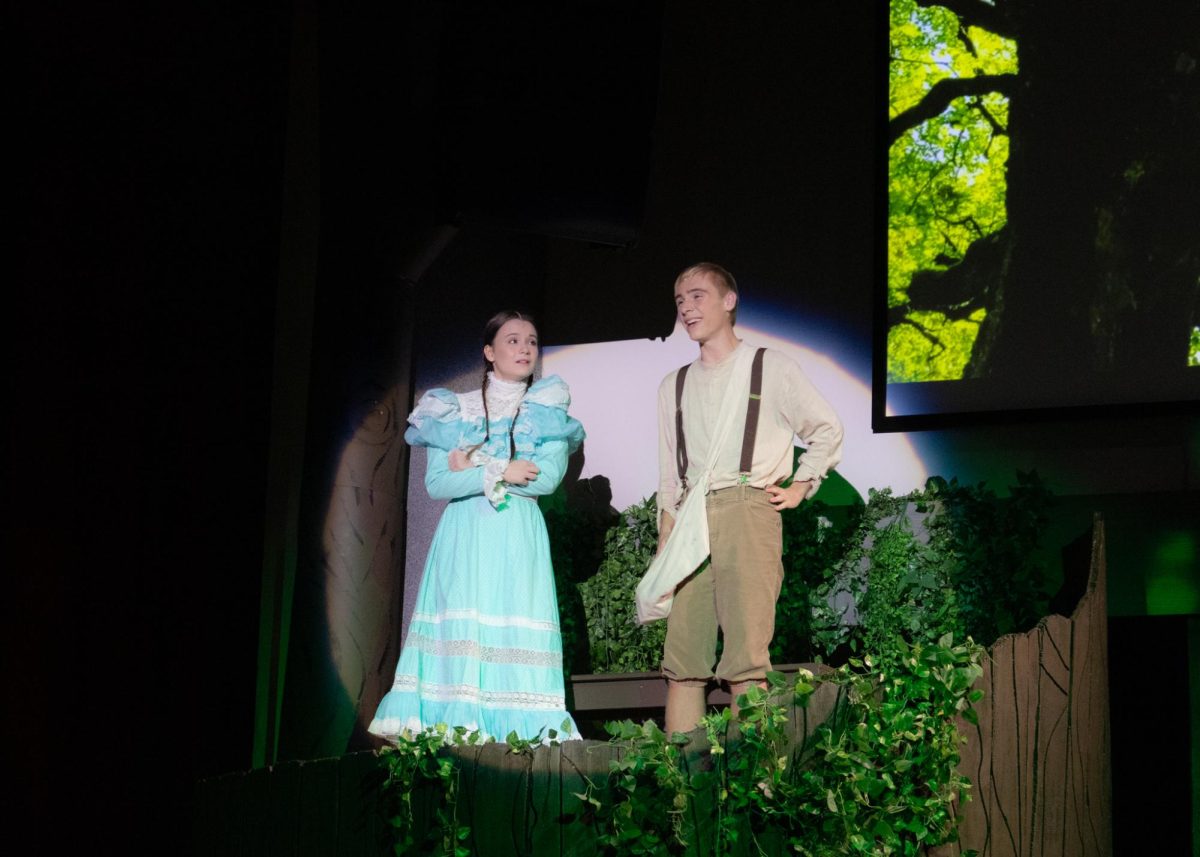 Seniors Nora Cowles and Gage Petrick sing as Winnie Foster and Jesse Tuck in "Tuck Everlasting."