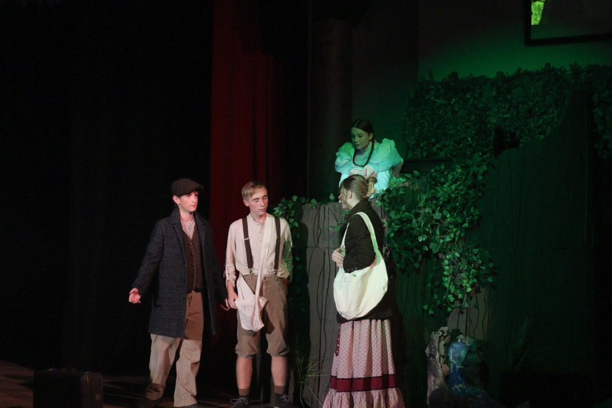 Nola Cowles eavesdrops on Gage Petrick, Trevor Gross, and Rylee Loonjer from a tree.