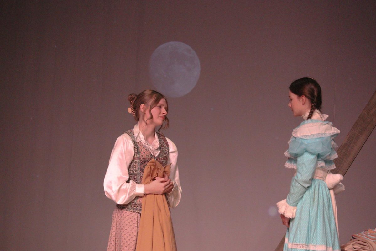 Rylee Loonjer sings to Nola Cowles in "Tuck Everlasting."
