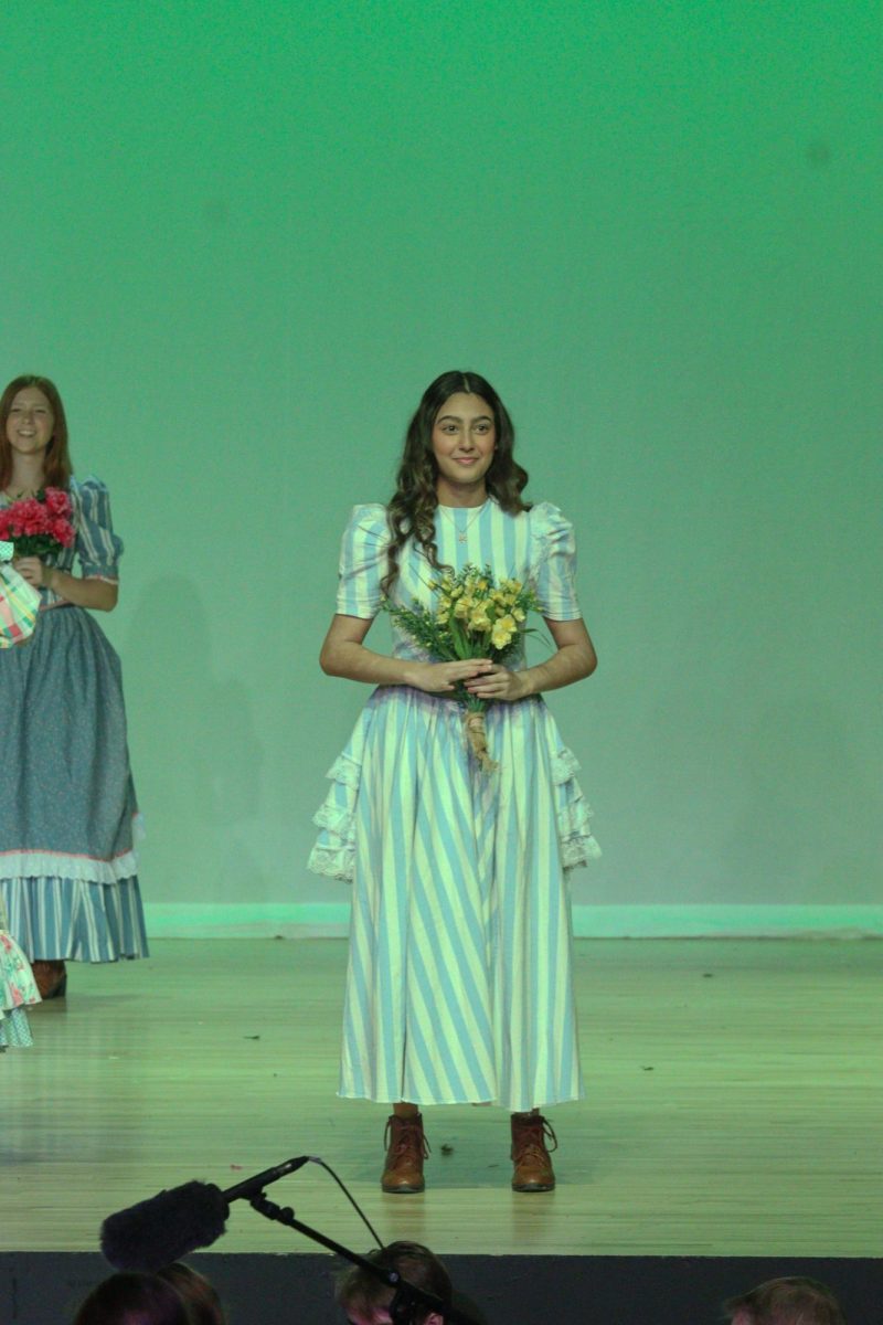 Junior Kyla Burhan takes the stage during the finale of "Tuck Everlasting."
