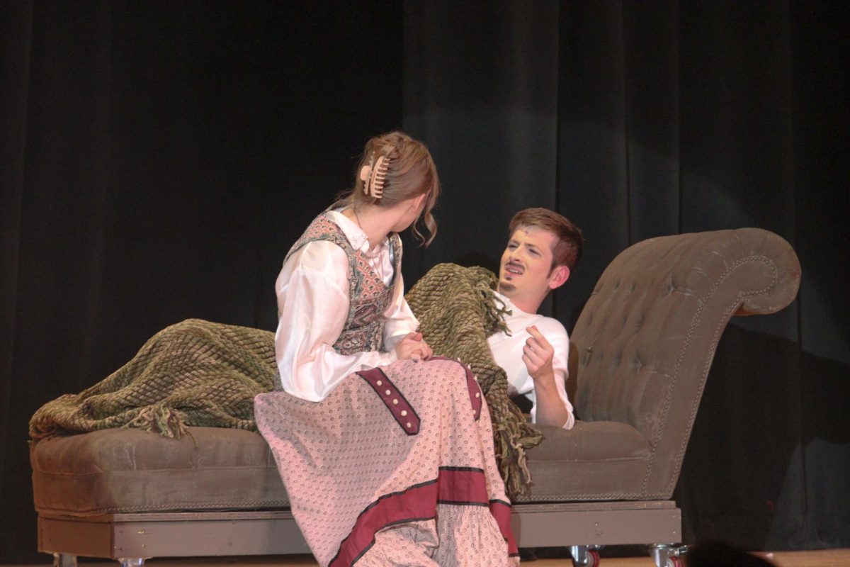 Sophomore Rylee Loonjer wakes up senior Christian Venditte in "Tuck Everlasting."