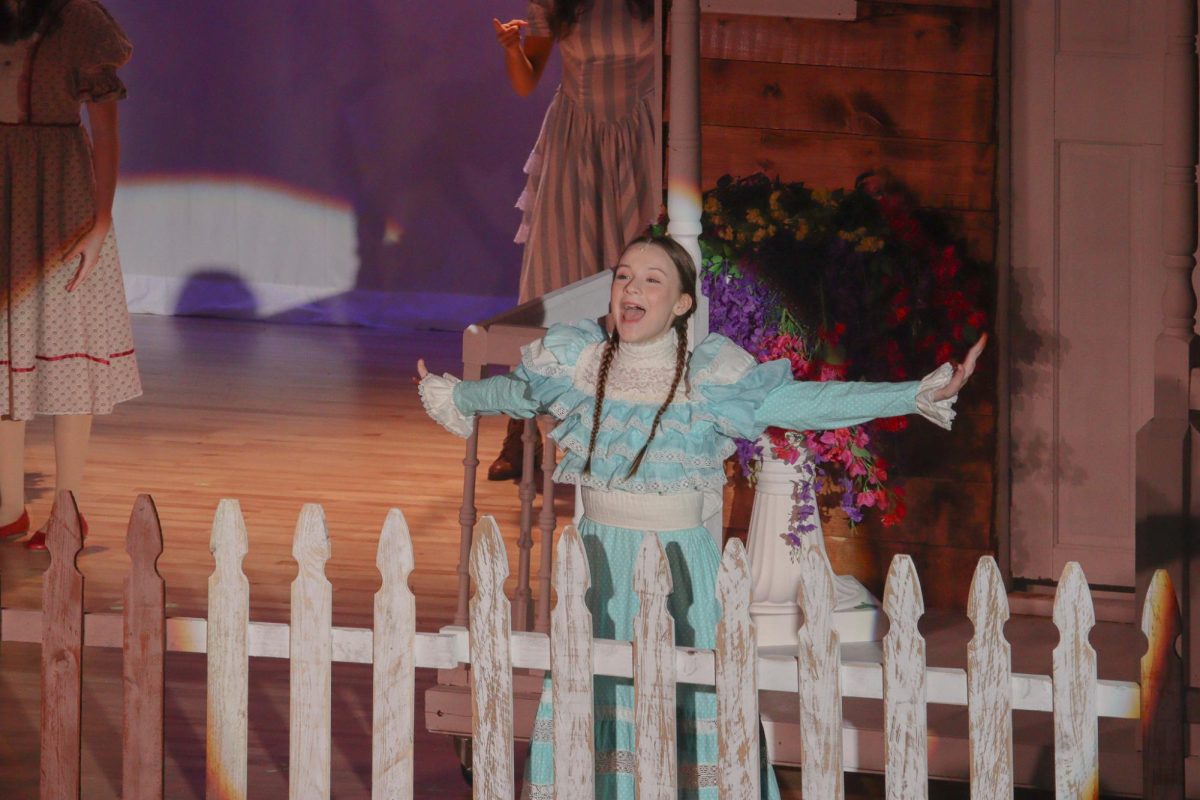 Senior Nora Cowles sings as Winnie Foster in "Tuck Everlasting."