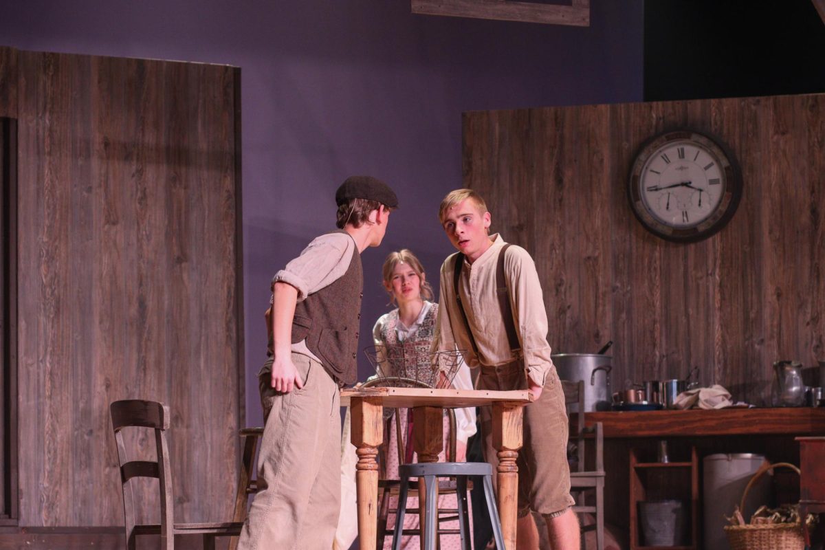 Senior Gage Petrick and sophomore Trever Gross, have an argument as brothers in "Tuck Everlasting."