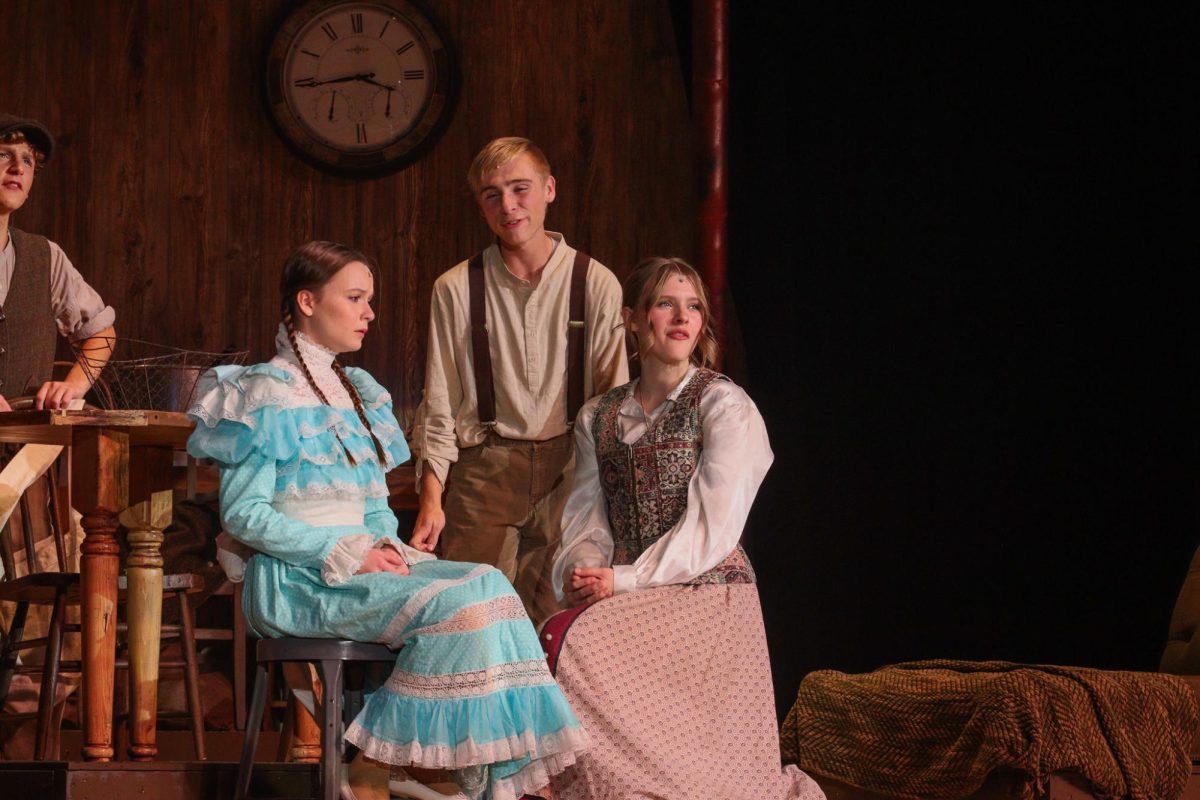 Sophomore Rylee Loonjer talks to senior Nola Cowles in the musical, Tuck Everlasting.