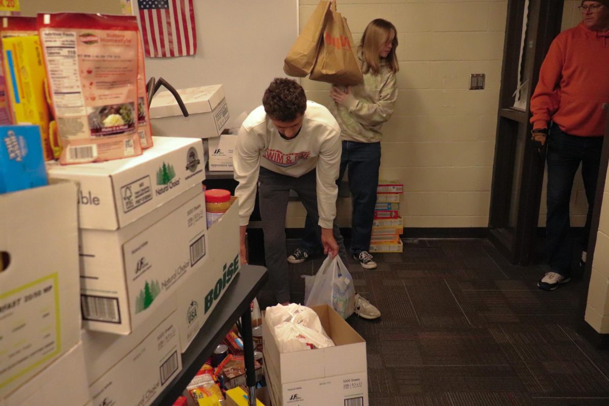 Students helping carry food in the 2025 food drive.