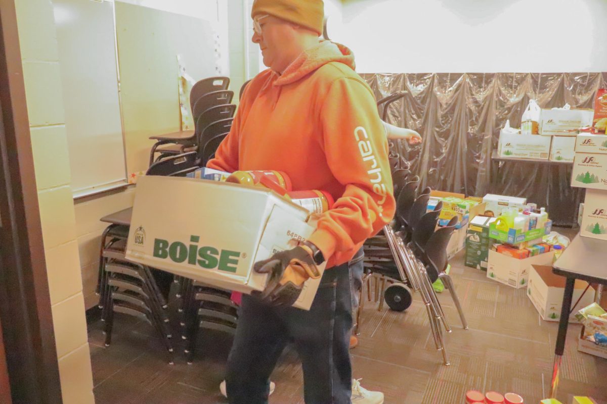 A worker helping carry food from the 2025 food drive