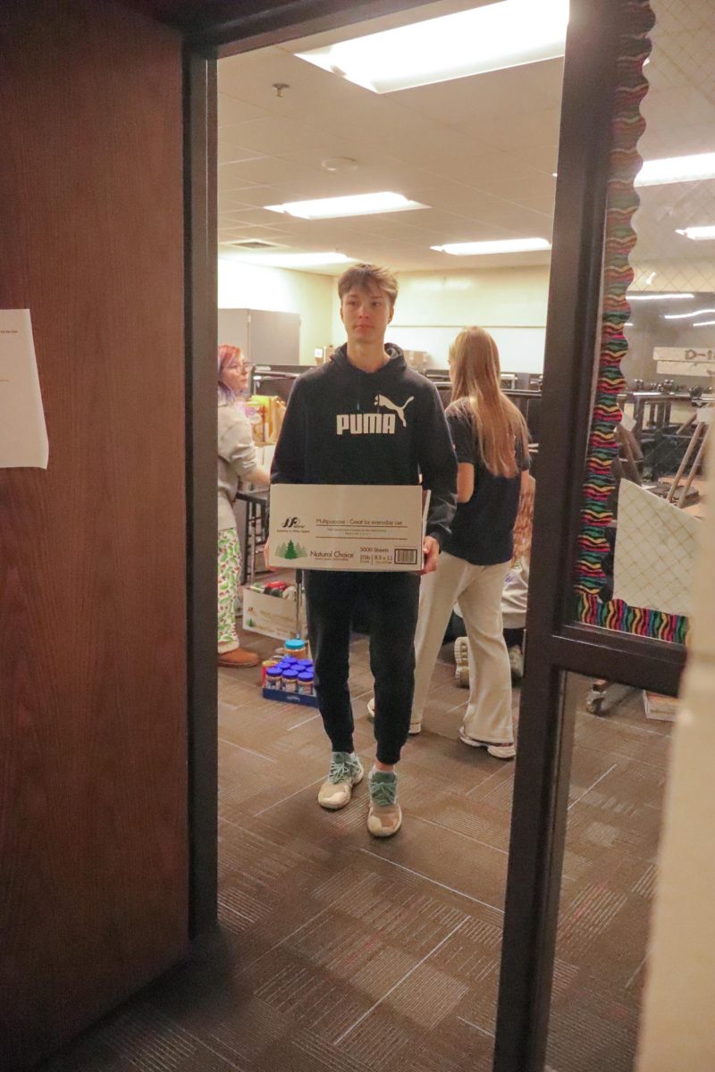 Junior, Alex Sharko, carrying food to the carrying trucks in the 2025 food drive