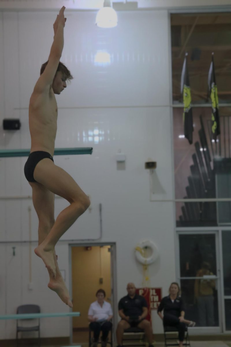 Senior Enzo Morello dives at the Burke diving invite.
