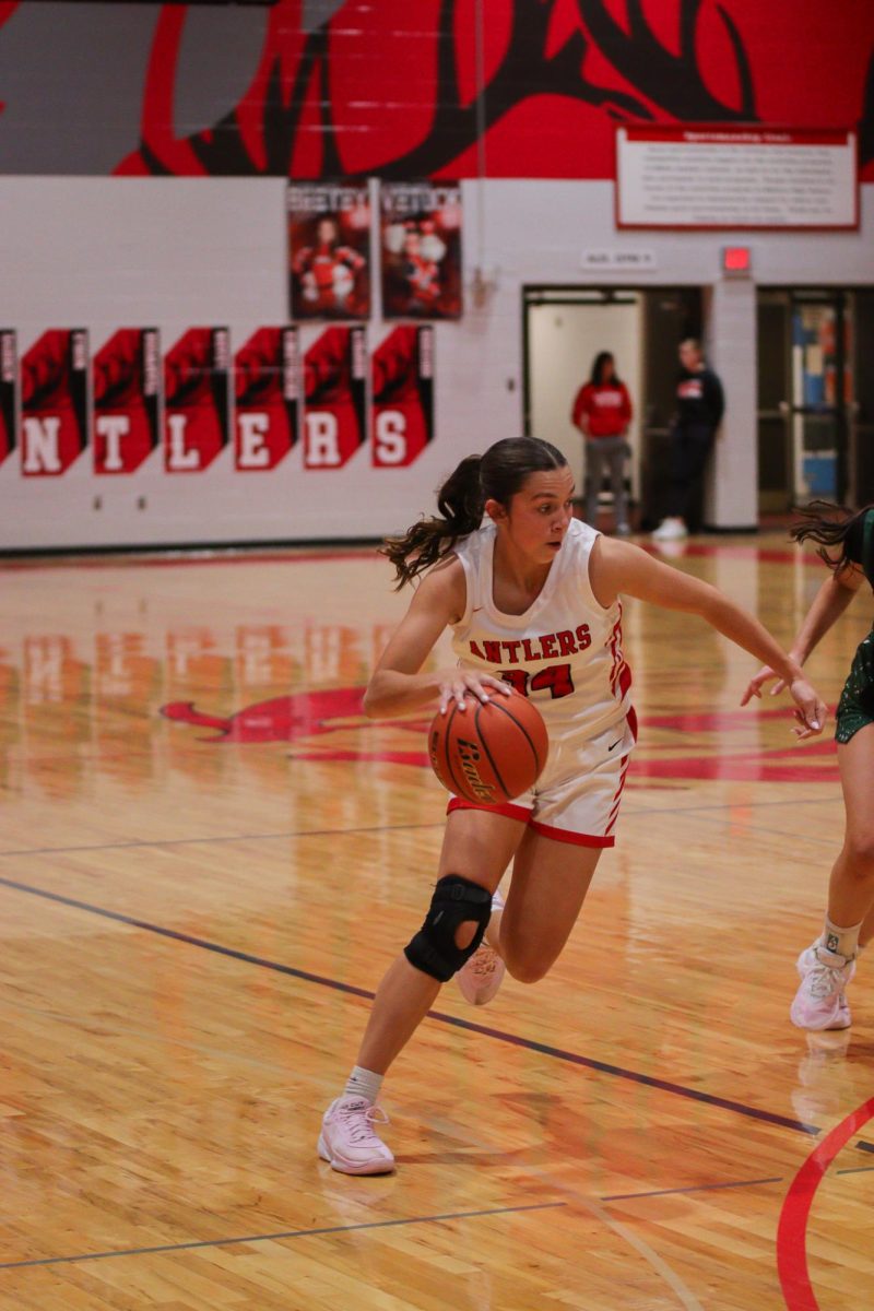 Sophomore Brooklyn Wragge drives around a Millard West defender. Elkhorn played the Wildcats in an exhibition jamboree. The first half score was 36-22. No official final score was kept.