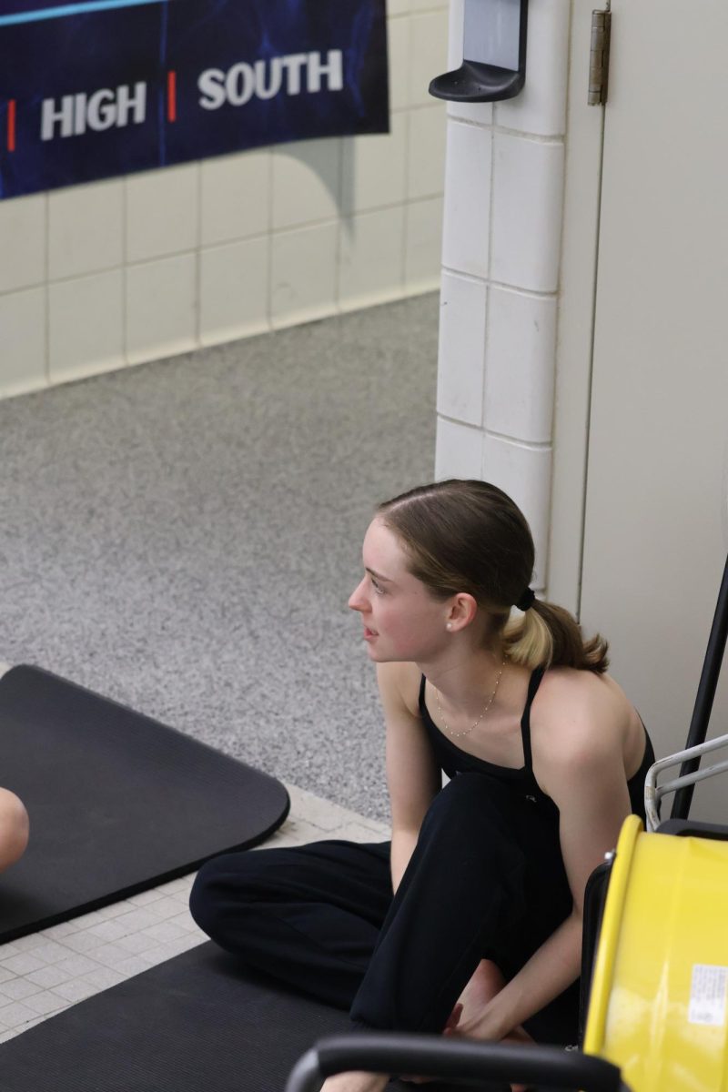 Senior Bridget Boster stretches at the senior swim and dive meet.