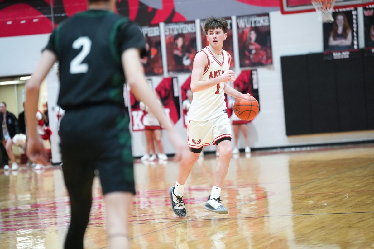 Senior, Nixon Farmer, dribbling the ball down the court and finding an open teammate for the bucket. 