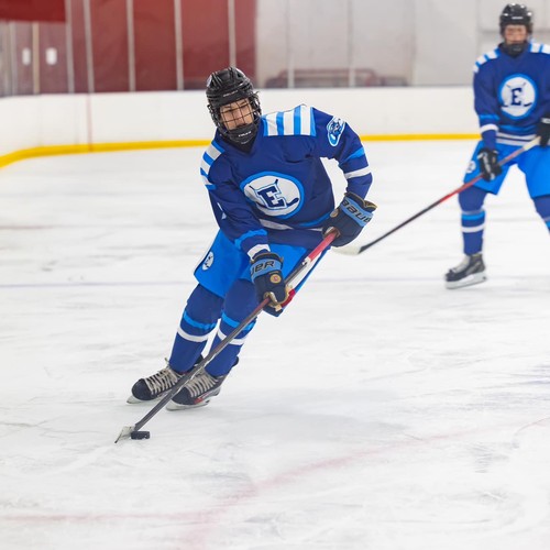 Senior Brian Strohman advances the puck during a recent game. Strohman scored the winning goal to send Elkhorn Blue to the state championship game.

Photo courtesy of Brian Strohman