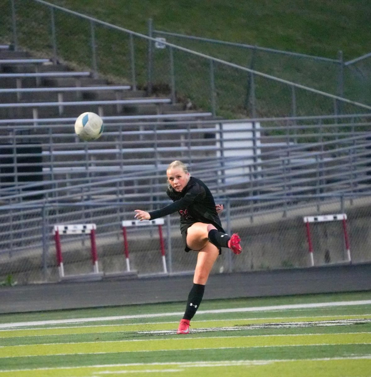 Senior Olivia Thompson kicks the ball from a free kick after getting fouled. Elkhorn beat Norris 3-0.