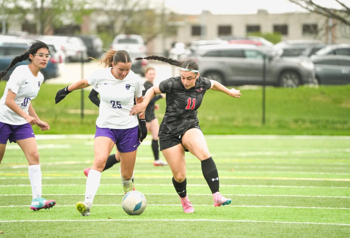 Junior Lulu Lary battles for the ball in a game against Lincoln Northwest. The Antlers won 9-0.
