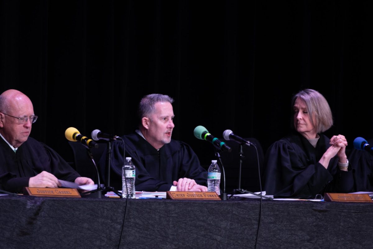 Justice Cassel, Chief Justice Funke, and Justice Stacy respond to a student's question during the Q and A session following the case hearings at EHS.