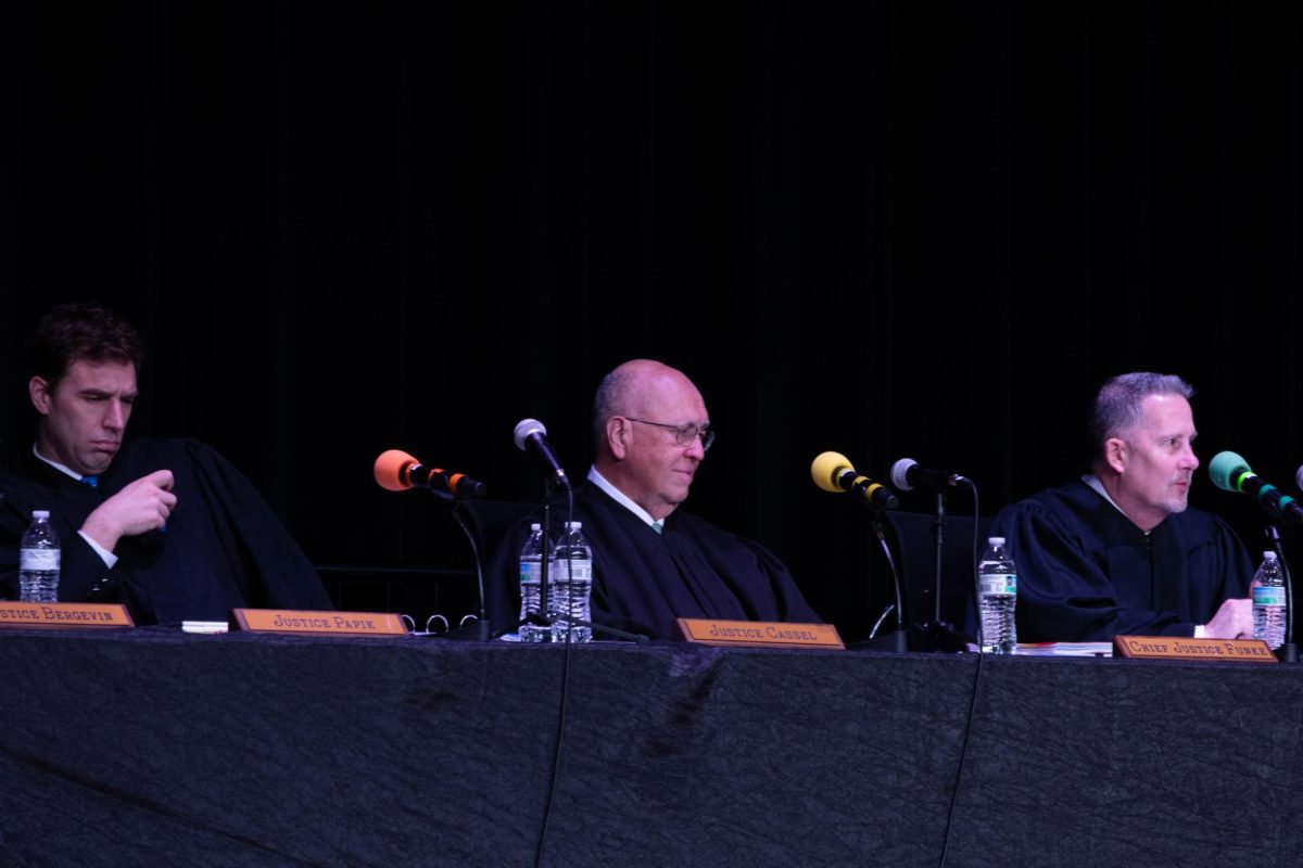 Justice Papik, Justice Cassel, and Chief Justice Funke respond to a student's question during the Q and A session following the case hearings at EHS.