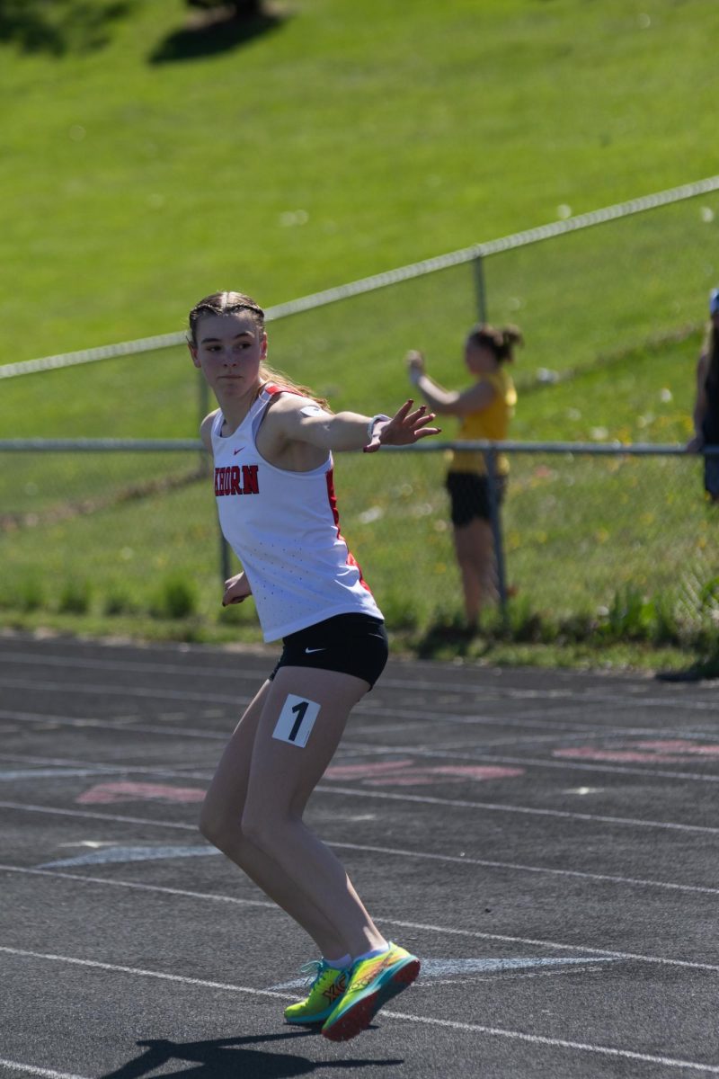 Junior Addison Washburn runs the 4 x 800 relay at the Kruger-May track meet, April 16, 2026.