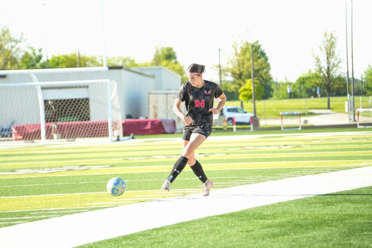 Sophomore, Katherine Rodgers, kicking the ball to her teammates to move it down the field. 