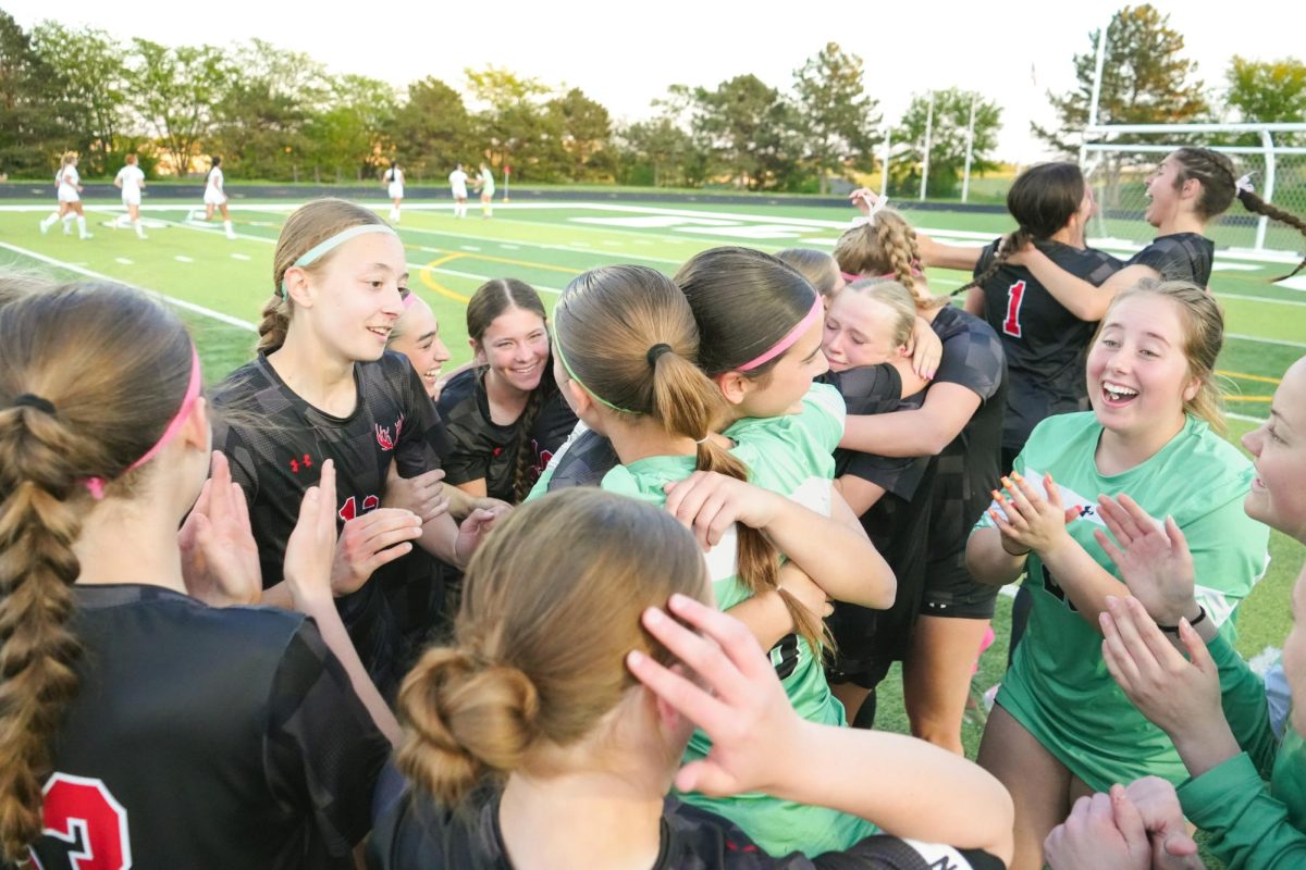 Antler soccer team hugging each other after a hard-fought win to advance to state. 