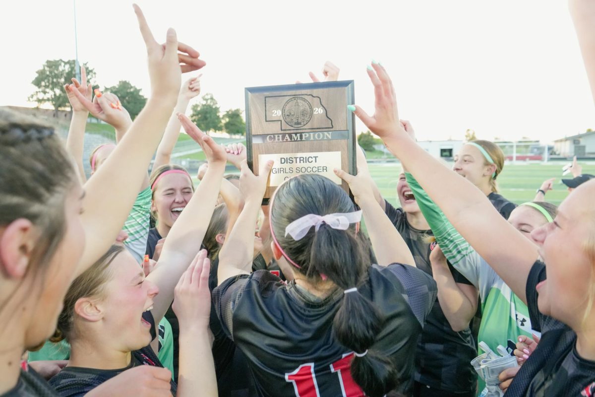 Antlers celebrate by holding up the plaque after beating Grand Island Northwest to win the district championship. 