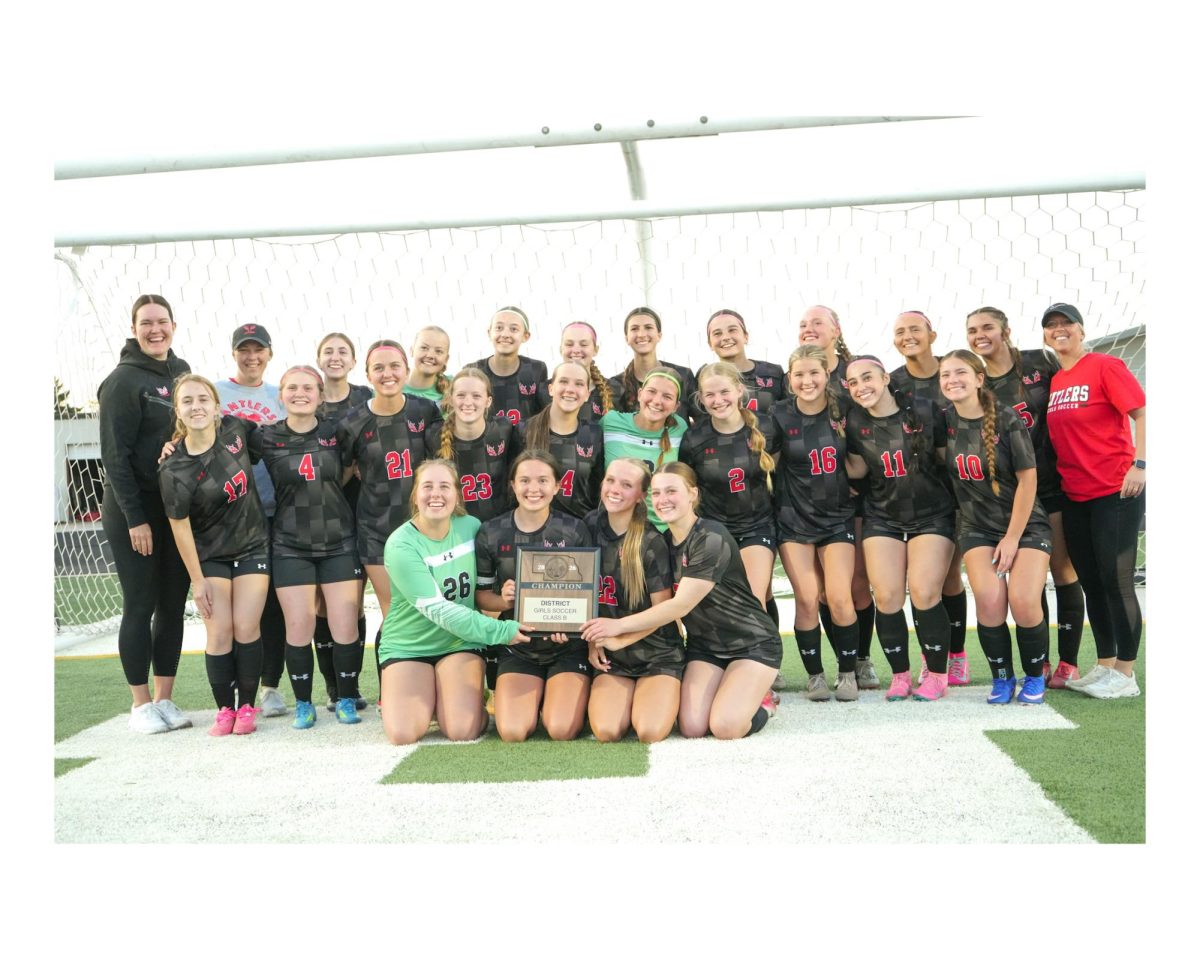 Antlers take a team picture with the plaque after beating Grand Island Northwest in the B-4 district championship to advance to state. 