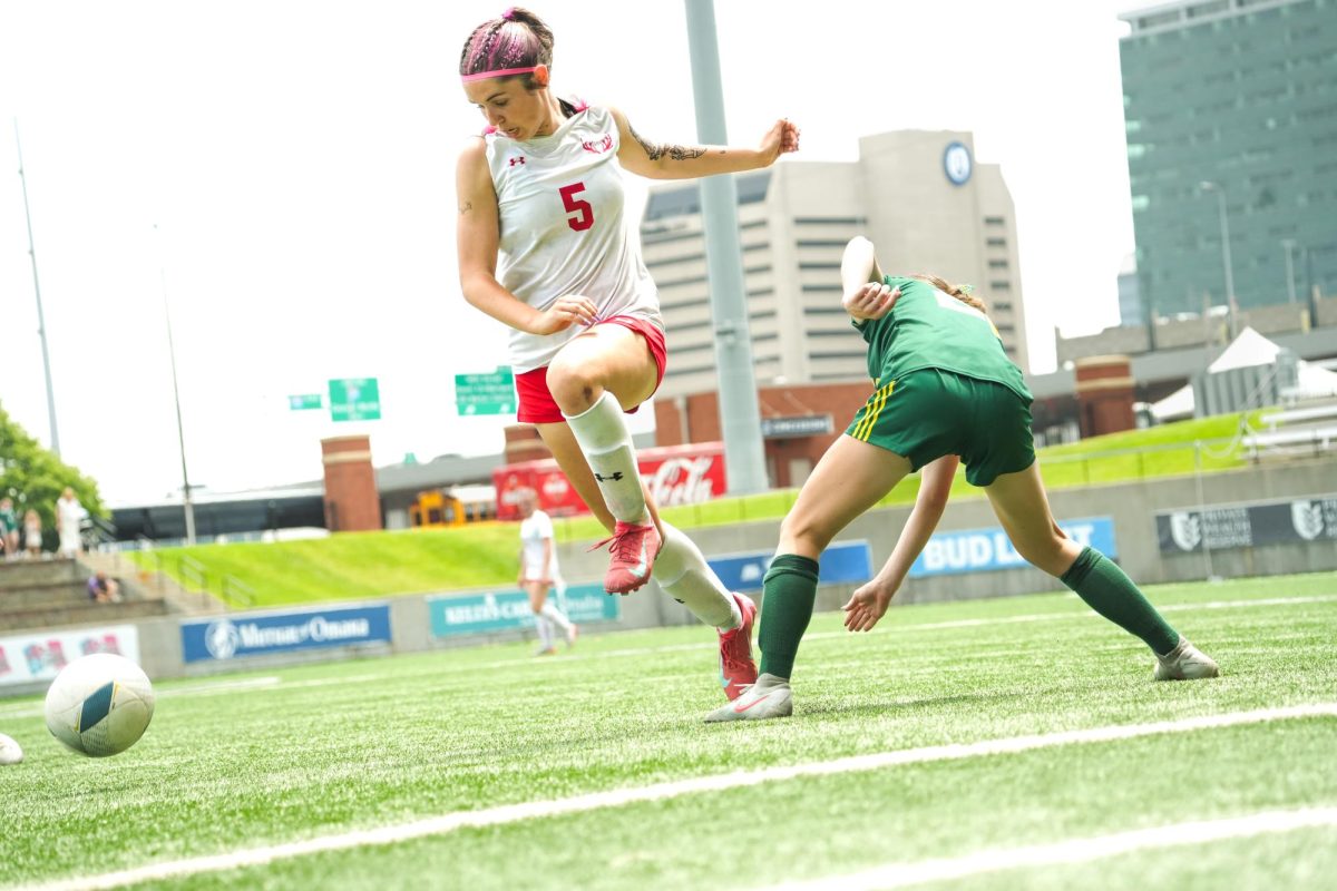 Junior, Molly Flynn, getting the ball past the Pius defender to take it down the field and get a shot on goal. 
