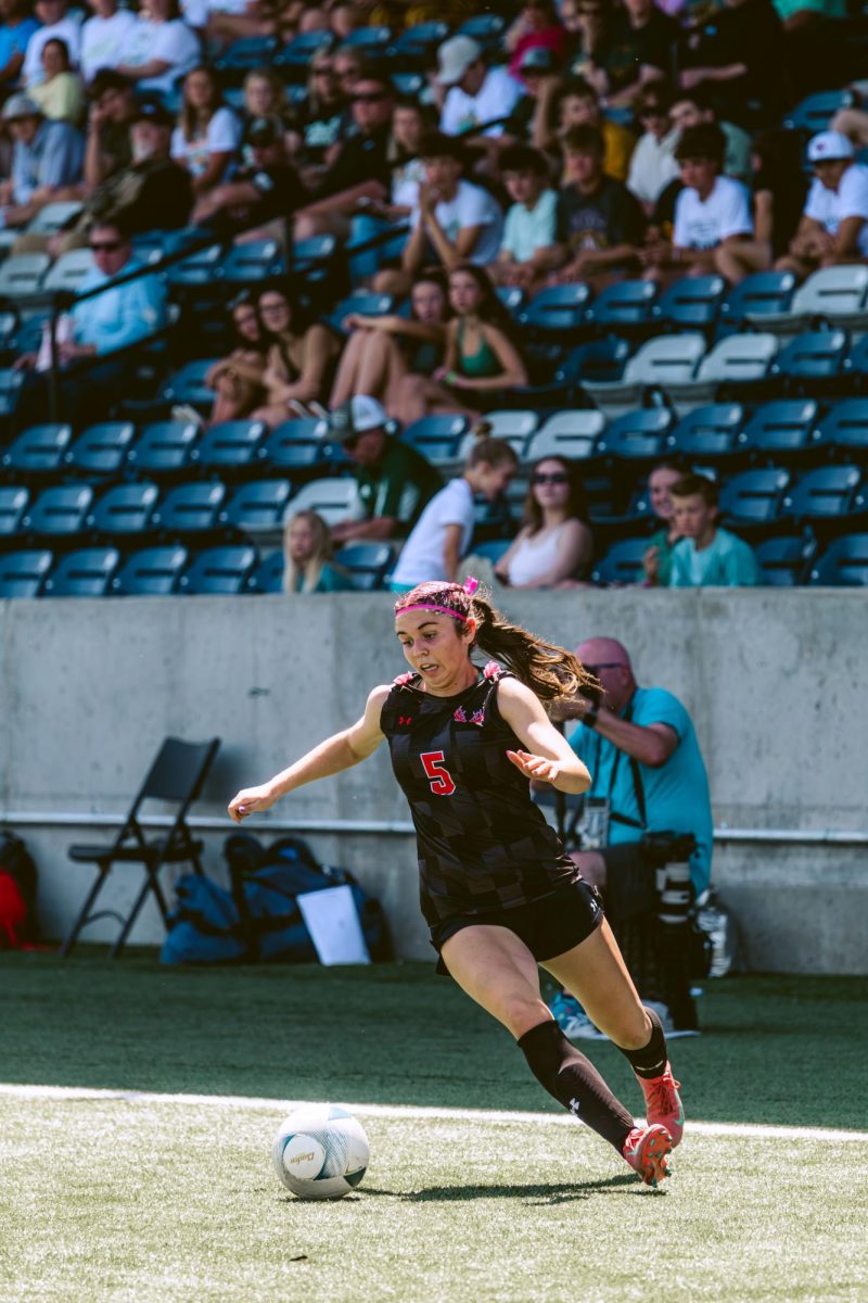 Junior Molly Flynn dribbles the ball toward the goal in the first round of the state tournament. The Antlers won 5-0.